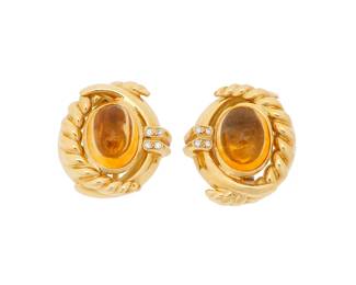 56
Joan Boyce: A Pair of 18K Gold and Citrine Earclips
Featuring two oval citrine cabochons measuring approximately 15.20 x 11.57 x 7.85 mm, accented by eight round diamonds all set in a high polish twisted gold design, signed JBL
2 pieces

Measures: 1 x 7/8 in.
33.4 grams gross
Estimate: $2,000 - $3,000