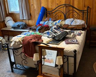 Full bed with mattress. Old wall clock. 