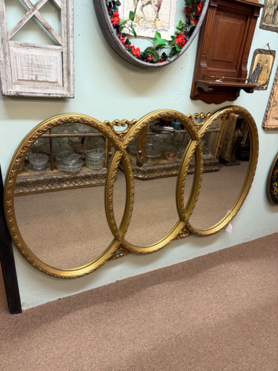 Vintage Hollywood Regency Triple Oval Wall Mirror in a gilded frame, also known as a "Wedding Ring Mirror"