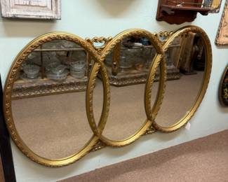 Vintage Hollywood Regency Triple Oval Wall Mirror in a gilded frame, also known as a "Wedding Ring Mirror"