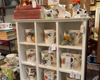 beautiful coffee mugs, dog figurines, books