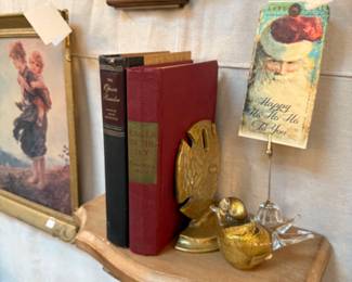 wall shelf, old books and sand dollar brass bookends