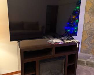 Flat screen TV and entertainment center with faux fire place and heat