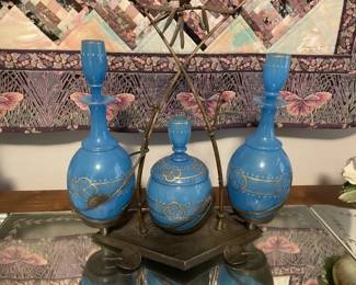 Set of 3 delicate decanters and serving dish on rack.