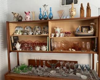Display wall unit (see previous pics).  Lower shelf includes:  Vaseline glass plates/cups/saucers; 3 holder candle holders, compote, deco glasses, crystal candleholders, coasters - see close up pics next