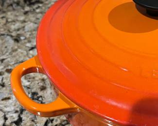 C9 - $125. Le Creuset #24 Dutch Oven Flame Orange. Small chip/ scratch on handle - otherwise in almost new condition. 