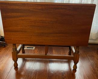 C48 - $75. Adorable Drop Leaf Table. The perfect size to use as an entry table or sofa table when not in use - or the right size for a 4 person dining table! Solid wood in very good condition with one exception - photographed. Measures 36" wide x 16" deep x 30" tall. Each Leaf adds 17.5". 