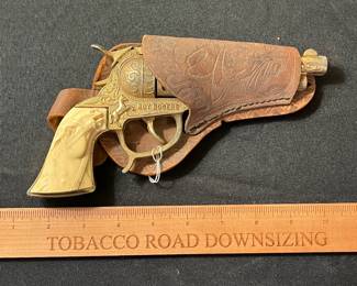 C59 - $60. Roy Rogers Forty Niner Pistol Cap Gun. Gold Plated. Comes with Red Ryder leather holster. 