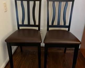 C46 - $40. PAIR of Wavy Back Dining Chairs. Black Wooden Frames with brown faux leather seat. Very good condition.Measures 18" wide x 38.5" tall. 