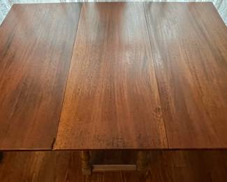 C48 - $75. Adorable Drop Leaf Table. The perfect size to use as an entry table or sofa table when not in use - or the right size for a 4 person dining table! Solid wood in very good condition with one exception - photographed. Measures 36" wide x 16" deep x 30" tall. Each Leaf adds 17.5". 