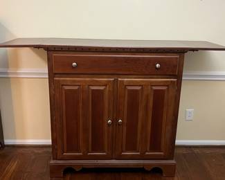 C17 - $125. *Tall* Server Cabinet. Measures 44" wide x 20" deep x 44.25" tall. Each drop leaf can add an extra 11.75". Drawer slides easily. Panel back needs reattached in a few places. 