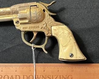C59 - $60. Roy Rogers Forty Niner Pistol Cap Gun. Gold Plated. Comes with Red Ryder leather holster. 