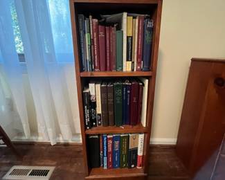 C33 - $30. Narrow - wooden bookcase. Measures 14" wide x 8" deep x 37" tall. 