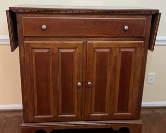 C17 - $125. *Tall* Server Cabinet. Measures 44" wide x 20" deep x 44.25" tall. Each drop leaf can add an extra 11.75". Drawer slides easily. Panel back needs reattached in a few places. 