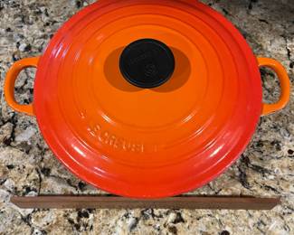 C9 - $125. Le Creuset #24 Dutch Oven Flame Orange. Small chip/ scratch on handle - otherwise in almost new condition. 