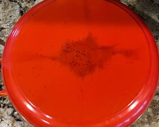 C9 - $125. Le Creuset #24 Dutch Oven Flame Orange. Small chip/ scratch on handle - otherwise in almost new condition. 