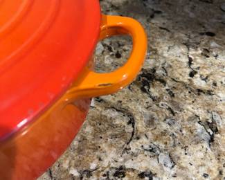 C9 - $125. Le Creuset #24 Dutch Oven Flame Orange. Small chip/ scratch on handle - otherwise in almost new condition. 