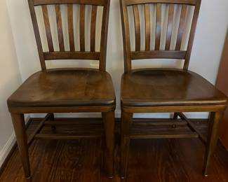C47 - $40 PAIR of vintage solid wood dining chairs. Both are sturdy - one has a crack in the seat. Measures 18.25" wide x 34.5" tall. 