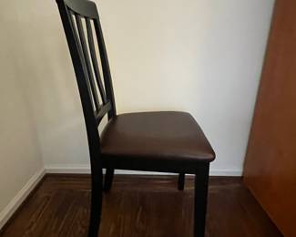 C46 - $40. PAIR of Wavy Back Dining Chairs. Black Wooden Frames with brown faux leather seat. Very good condition.Measures 18" wide x 38.5" tall. 