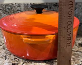 C9 - $125. Le Creuset #24 Dutch Oven Flame Orange. Small chip/ scratch on handle - otherwise in almost new condition. 