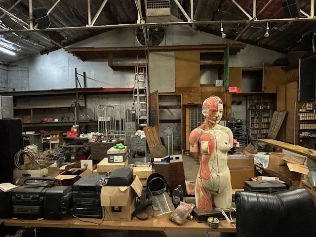 jambox, speakers of all sizes, welding goggles, protective masks, super cool early anatomical model (with guts), racks carts and raw steel. 