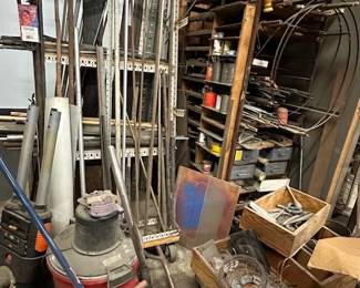 4 shop vacs, steel racks, bins and parts and pieces 