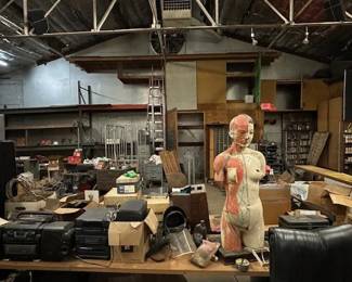 jambox, speakers of all sizes, welding goggles, protective masks, super cool early anatomical model (with guts), racks carts and raw steel. 