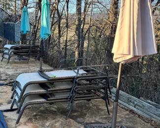 Numerous umbrellas and metal lounge chairs