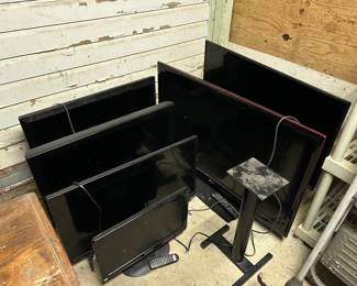 LOTS OF TVS OF DIFFERENT SIZES.