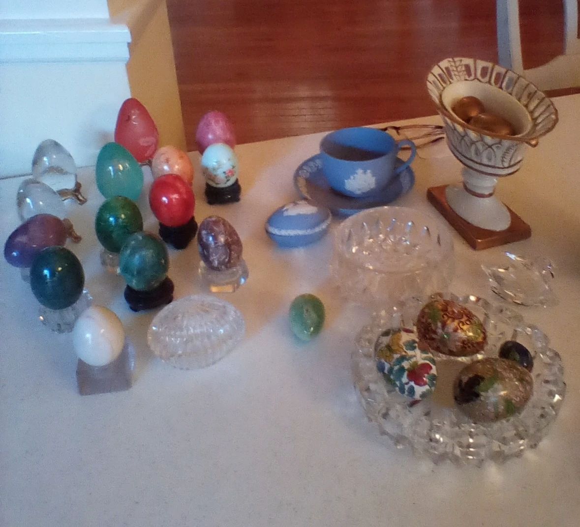 Crystal eggs, Wedgwood egg with tea cup and saucer, Jane Hucheson 4 in reticulated vase with brass eggs, Swarovski crystal swan