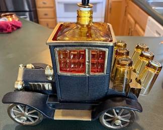 Metal. Model T 1915 Ford. Bar ware. Decanter w/ shot glasses. Musical car. Did not get it to play music. HiBid link: https://modestlambestatesales.hibid.com/