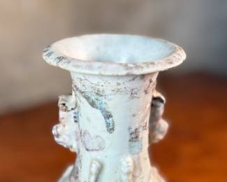 This lot features an antique Chinese sandy glazed vase that measures, 10” H x 4” W x 4” D.
