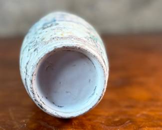 This lot features an antique Chinese sandy glazed vase that measures, 10” H x 4” W x 4” D.
