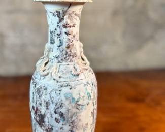 This lot features an antique Chinese sandy glazed vase that measures, 10” H x 4” W x 4” D.
