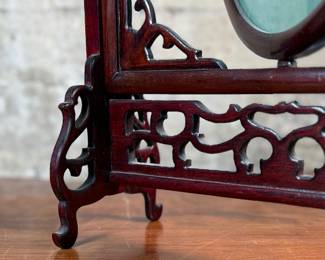 This lot features a vintage Chinese double-sided silk embroidery table screen featuring a a cat on each side, housed in a carved wooden display stand. This piece measures, 17” H x 13” W x 5” D.
