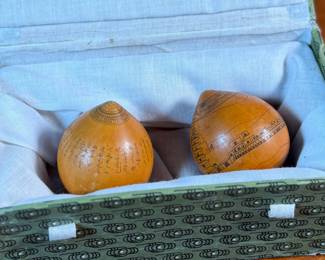 This lot features a pair of Chinese Lanzhou etched gourds displayed in a box. This type of gourd carving is a traditional folk art unique to Lanzhou, China, where carvers use fine tools to engrave landscapes, figures, and calligraphy onto the surface of the gourds. 
