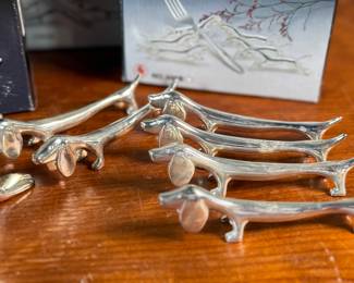 Proceeds from this lot will be donated to non-profit Salem Dogs in Marion County, Oregon. This lot features a set of twelve (12) dachshund fork holders & a silver plated seal bottle opener. All items come in their original packaging. Salem Dogs focus is on helping special needs dogs when their people experience extreme circumstances. Owner death, hospice, and nursing/assisted living situations are some examples that trigger the need for a new home. In addition, some people find themselves unable to afford medical bills and opt to have their dog euthanized. In those cases, Salem Dogs is often contacted and has either taken in the dog or helped the owner financially. While most of their work is in the Salem, Oregon area, this charity has helped dogs in multiple areas around North America.
