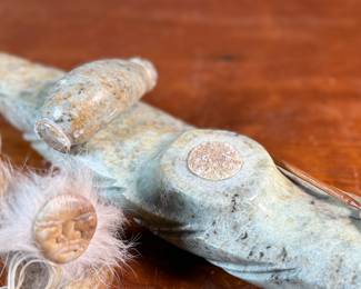 This lot features a hand-carved soapstone sculpture of an Inuit hunter and kayak. Signed underneath and measures, 6” H x 15” W x 3” D. The hunter has come detached as shown in photos and can sit just fine or be reattached.
