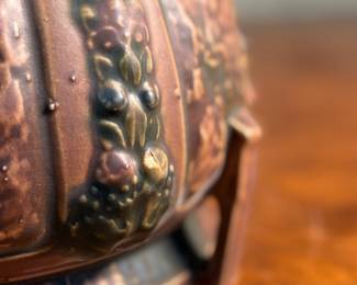 This lot features an antique jardiniere by Roseville Pottery from the "Florentine" pattern, introduced circa 1924. This specific line is known for its Arts and Crafts style, featuring a blend of simple shapes and detailed relief designs. Two small chips shown in photos and measures, 6.25” H x 9” W x 9” D.
