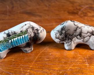 This lot features a pair of beautiful Native American Navajo horse hair pottery buffalo sculptures. Both are signed by artists as shown in photos and each measures, 4” H x 6.5” W x 1.25” D.
