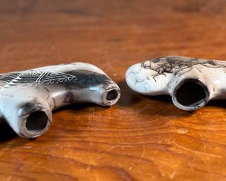 This lot features a pair of beautiful Native American Navajo horse hair pottery buffalo sculptures. Both are signed by artists as shown in photos and each measures, 4” H x 6.5” W x 1.25” D.
