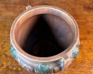 This lot features an antique jardiniere by Roseville Pottery from the "Florentine" pattern, introduced circa 1924. This specific line is known for its Arts and Crafts style, featuring a blend of simple shapes and detailed relief designs. Two small chips shown in photos and measures, 6.25” H x 9” W x 9” D.
