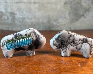 This lot features a pair of beautiful Native American Navajo horse hair pottery buffalo sculptures. Both are signed by artists as shown in photos and each measures, 4” H x 6.5” W x 1.25” D.
