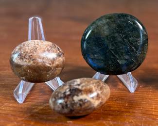 This lot features a collection of palm stones in excellent condition. The sodalite weighs 2.3oz and measures 3”, the labradorite weighs 5oz and measures 3”, and the pair of black opalite palm stones weigh 2.2oz each and measure, 2.5”.
