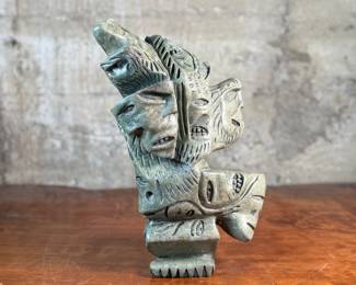 This lot features a stunning Inuit spirit carving in green soapstone by listed Inuit artist, Tytosie Tunnillie. Signed underneath as shown in photos and measures, 13” H x 8.5” W x 4.5” D.
