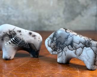 This lot features a pair of beautiful Native American Navajo horse hair pottery buffalo sculptures. Both are signed by artists as shown in photos and each measures, 4” H x 6.5” W x 1.25” D.
