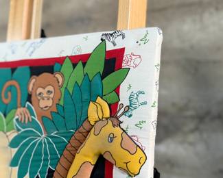 This lot features a safari animal quilt fabric that has been mounted and is ready to hang and display! This piece measures, 34” H x 26” W.
