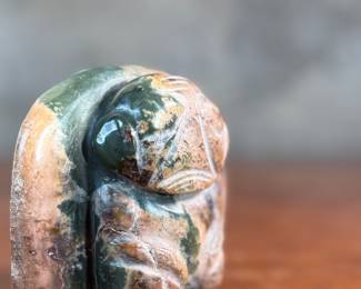 This lot features a hand-carved Inuit stone sculpture that measures, 4” H x 4” W x 2” D.
