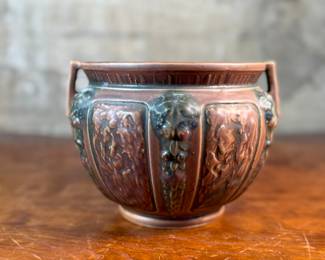 This lot features an antique jardiniere by Roseville Pottery from the "Florentine" pattern, introduced circa 1924. This specific line is known for its Arts and Crafts style, featuring a blend of simple shapes and detailed relief designs. Two small chips shown in photos and measures, 6.25” H x 9” W x 9” D.
