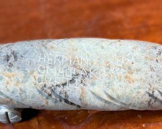 This lot features a hand-carved soapstone sculpture of an Inuit hunter and kayak. Signed underneath and measures, 6” H x 15” W x 3” D. The hunter has come detached as shown in photos and can sit just fine or be reattached.
